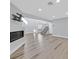 Open-concept living room with sleek floors, a fireplace, and contemporary design elements at 5421 Painted Mirage Rd, Las Vegas, NV 89149