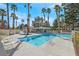 Sparkling pool surrounded by palm trees and lounge chairs, perfect for relaxation and recreation at 5421 Painted Mirage Rd, Las Vegas, NV 89149