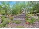 Painted Desert community sign amidst lush landscaping with mature trees and colorful plants, offering a welcoming entrance at 5421 Painted Mirage Rd, Las Vegas, NV 89149