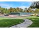 Well-maintained tennis courts surrounded by lush landscaping, creating a private and inviting recreational space at 5421 Painted Mirage Rd, Las Vegas, NV 89149
