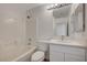 Bathroom with tub and shower combination and bright vanity at 5861 Secret Island Dr, Las Vegas, NV 89139