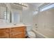 Bathroom with wood vanity, shower-tub combo and window at 5861 Secret Island Dr, Las Vegas, NV 89139