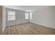Spacious bedroom with wood floors and two windows for natural light at 5861 Secret Island Dr, Las Vegas, NV 89139
