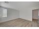 Bright bedroom features wood-look floors and large window at 5861 Secret Island Dr, Las Vegas, NV 89139