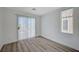 Bedroom with wood-style flooring, sliding door, and natural light at 5861 Secret Island Dr, Las Vegas, NV 89139