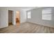 Bright bedroom features wood-look floors and two windows at 5861 Secret Island Dr, Las Vegas, NV 89139