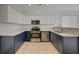 A modern kitchen featuring stainless steel appliances and two-tone cabinets at 5861 Secret Island Dr, Las Vegas, NV 89139