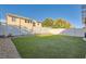 Grassy backyard featuring a privacy fence with desert landscaping and a well-maintained lawn at 5958 W Agate Ave, Las Vegas, NV 89139