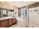 Bathroom featuring a double sink vanity, bathtub, and stand-up shower at 5958 W Agate Ave, Las Vegas, NV 89139