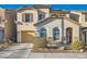 Two-story stucco home featuring a one car garage, desert landscaping, and shutters on the second story windows at 5958 W Agate Ave, Las Vegas, NV 89139