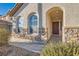 Covered porch features stone accents, arched entryways, and a welcoming front door perfect for guests at 5958 W Agate Ave, Las Vegas, NV 89139