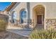 Inviting front porch with arched windows and stone detailing, providing a charming entrance to the home at 5958 W Agate Ave, Las Vegas, NV 89139
