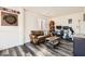 Spacious game room with wood floors, a comfortable couch, dart board, and work station at 5958 W Agate Ave, Las Vegas, NV 89139