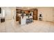 Open kitchen featuring a central island with barstool seating and warm wood cabinetry at 5958 W Agate Ave, Las Vegas, NV 89139