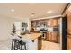 Well-appointed kitchen features granite countertops, stainless steel appliances, and a breakfast bar with seating at 5958 W Agate Ave, Las Vegas, NV 89139