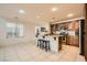 Well-lit kitchen area with granite countertops and dark brown wood cabinetry at 5958 W Agate Ave, Las Vegas, NV 89139