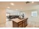 Bright kitchen with an island, stainless steel appliances, and a view into the adjacent living area at 5958 W Agate Ave, Las Vegas, NV 89139