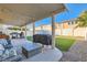 View of the shaded patio with ceiling beams, with grilling station, sofa, and low table at 5958 W Agate Ave, Las Vegas, NV 89139