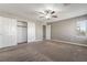 Bedroom with carpet, ceiling fan, window with blinds, and closet with sliding doors at 7222 Regent Pond St, Las Vegas, NV 89166