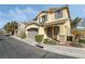 Charming home featuring tan stucco, a two-car garage, stone accents, and well-maintained landscaping at 7222 Regent Pond St, Las Vegas, NV 89166