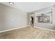 Bright living room with wood floors, neutral paint, view of staircase, and an open floor plan at 7222 Regent Pond St, Las Vegas, NV 89166