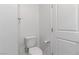 Bathroom featuring a toilet, towel rack, and a white door, showcasing clean and simple design at 7256 Saxby Ave, Las Vegas, NV 89113