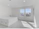 A sunlit bedroom features carpet, a stylish headboard, and large windows with neighborhood views at 7256 Saxby Ave, Las Vegas, NV 89113