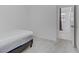 Bedroom showcasing a modern bed frame and doorway leading to the hall in a room with neutral decor at 7256 Saxby Ave, Las Vegas, NV 89113