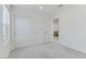 Bedroom with sliding closet, neutral carpet, and a glimpse into the living space at 7256 Saxby Ave, Las Vegas, NV 89113