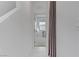 Bright hallway with white walls and tile flooring leading to a room with natural light and a neutral color scheme at 7256 Saxby Ave, Las Vegas, NV 89113