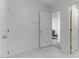 Hallway view of the walk-in closet with wire shelves and adjacent bedroom at 7256 Saxby Ave, Las Vegas, NV 89113