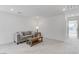 Spacious living room with a comfortable couch, modern decor, and a bright window, ideal for relaxing and entertaining at 7256 Saxby Ave, Las Vegas, NV 89113