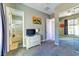 Bedroom with carpet, dresser with TV, ensuite bath, and mirrored closet doors at 8209 Chapelle Ct, Las Vegas, NV 89131