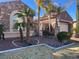 Charming single-story home with a desert landscaped front yard, mature palms, and gated entrance at 8209 Chapelle Ct, Las Vegas, NV 89131