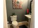 Neat powder room with a pedestal sink, tiled floors, and colorful artwork at 8209 Chapelle Ct, Las Vegas, NV 89131