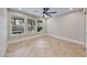 Inviting bedroom with a ceiling fan, large windows, and herringbone wood flooring at 1700 Monte Rio Ct, Las Vegas, NV 89128