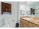 Bathroom featuring rustic wood storage cabinet and a sink with tan tiled countertop at 101 Luna Way # 226, Las Vegas, NV 89145