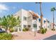 Exterior view of a multi-story residential building featuring palm trees and desert landscaping at 101 Luna Way # 226, Las Vegas, NV 89145