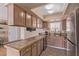 Functional kitchen area with tiled countertops and wood cabinetry at 101 Luna Way # 226, Las Vegas, NV 89145