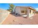 The backyard features a covered patio, desert landscaping, and a block wall at 1035 Dodger Blue Ave, Las Vegas, NV 89123