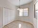 Dining room features neutral colors, tile flooring, and a closet with a large window for plenty of natural light at 1035 Dodger Blue Ave, Las Vegas, NV 89123