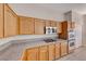 Kitchen features granite countertops, natural wood cabinets, stainless steel appliances, double oven, and gas cooktop at 1035 Dodger Blue Ave, Las Vegas, NV 89123