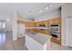 Bright kitchen with center island, stainless steel appliances, granite counters, and plentiful wooden cabinets at 1035 Dodger Blue Ave, Las Vegas, NV 89123