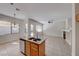 Kitchen island and sink overlooking living area with fireplace and backyard access at 1035 Dodger Blue Ave, Las Vegas, NV 89123