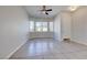 Sunlit living area with tile flooring, large windows, and a neutral color palette at 1035 Dodger Blue Ave, Las Vegas, NV 89123