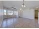 Open-concept living room with tile flooring, ceiling fan, and large windows for natural light at 1035 Dodger Blue Ave, Las Vegas, NV 89123