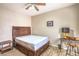 Bedroom with a ceiling fan, desk, and a wooden bedframe with built in drawers at 10431 Kitty Joyce Ave, Las Vegas, NV 89129