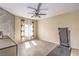 Bright bedroom with wood floors, a ceiling fan, and curtains accenting the natural light from the window at 10431 Kitty Joyce Ave, Las Vegas, NV 89129