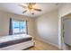 Bright bedroom with wood floors and a window offering natural light, creating a warm and inviting atmosphere at 10431 Kitty Joyce Ave, Las Vegas, NV 89129