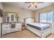 Stylishly decorated bedroom features wood floors, a cozy bed, and a dresser with a unique mirror at 10431 Kitty Joyce Ave, Las Vegas, NV 89129